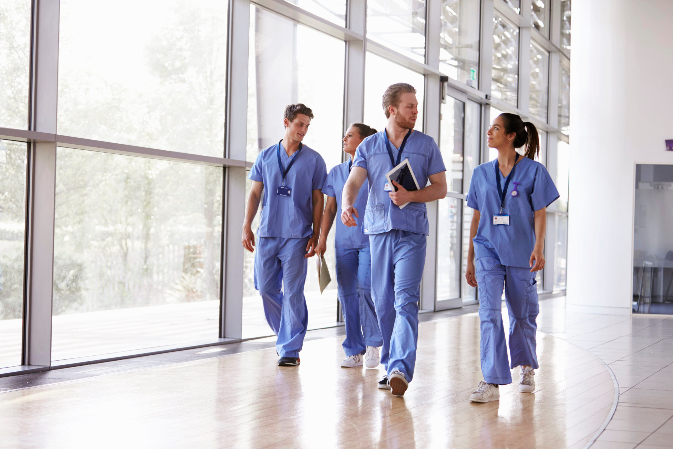 Healthcare team walking through a hospital corridor
